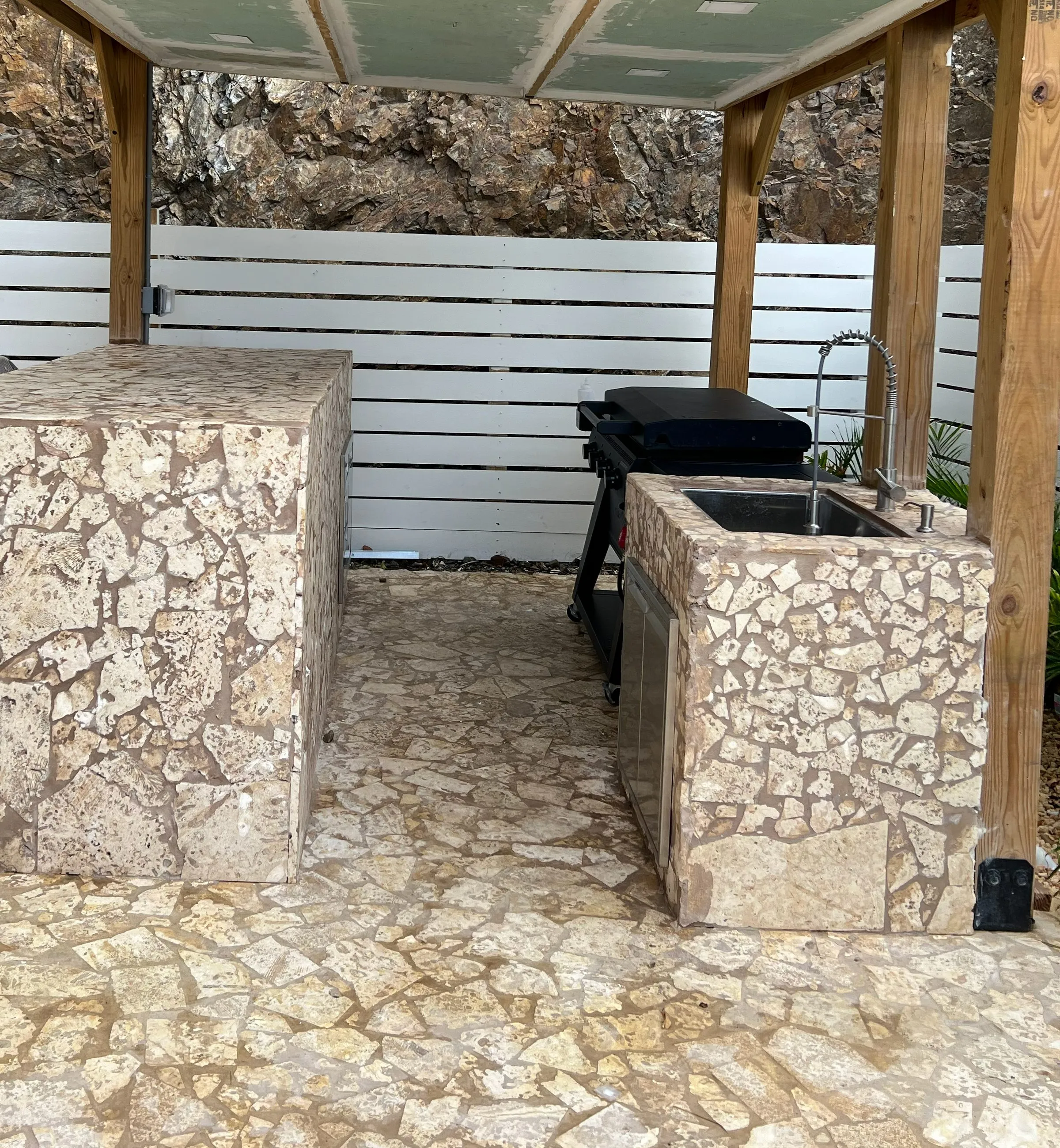 Covered outdoor kitchen and bar at the villa